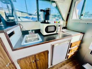 a small kitchen with a sink and a microwave at Buffalo’s River Den in Buffalo +21 photos