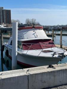 a boat sitting in the water next to a dock at Buffalo’s River Den in Buffalo