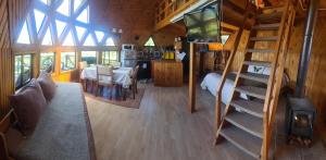 a living room with a staircase in a tiny house at Turismo del Bosque in Castro