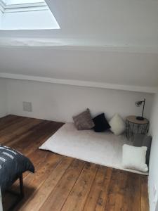 a white room with a bed with pillows on it at Maison Isola Village in Isola +5 photos