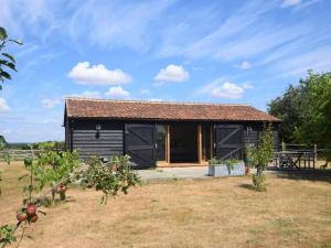 a log cabin with a garden and trees at 1 Bed in Colchester 58576 