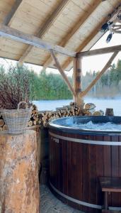 a hot tub in a wooden building with a wooden ceiling at Janoś pokoje gościnne in Białka Tatrzańska