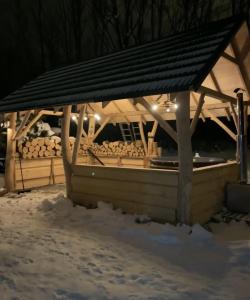 a gazebo in the snow at night at Janoś pokoje gościnne in Białka Tatrzańska
