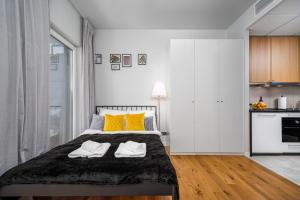 una camera da letto con un letto e due asciugamani di Apart D&K Free Parking Aleja Prymasa Tysiąclecia 83A a Varsavia