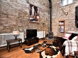 a stone walled living room with a couch and a tv at 1 Bed in Flash 58958 in Flash