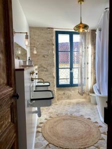 a bathroom with two sinks and a tub and a window at La Belle Vie du Vexin , à une heure de Paris in Parnes
