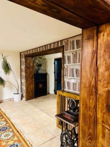 a room with a wooden wall with bookshelves at Iepurasul Sinaia in Sinaia