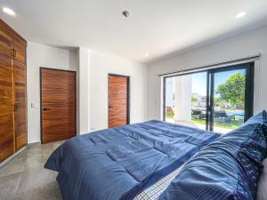 a bedroom with a large bed and a large window at Villa Bliss by Lumina in Cabo San Lucas
