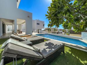 a backyard with a swimming pool and a house at Villa Bliss by Lumina in Cabo San Lucas