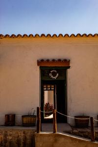 a doorway to a building with a clock on it at El Progreso Molinos in Molinos