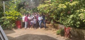 um grupo de pessoas posando para uma foto em um jardim em Vacanza Estate House em Kakkabe