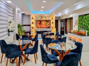a restaurant with tables and chairs and a fireplace at Hotel del Valle in Huancayo