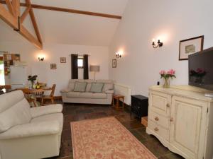 a living room with a couch and a tv at 2 Bed in Sherborne FOLKI in Long Burton