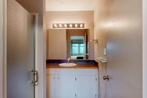 a bathroom with a sink and a mirror at Nye Beach Condo in Newport