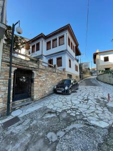 a car parked in front of a house at Varousi House in Tríkala