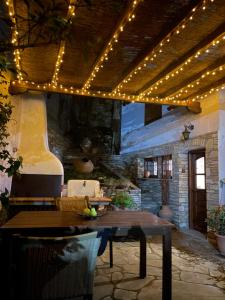 a patio with a table and string lights at Under the Castle in Tríkala