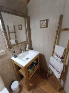 a bathroom with a sink and a mirror and a chair at Casa Coba 