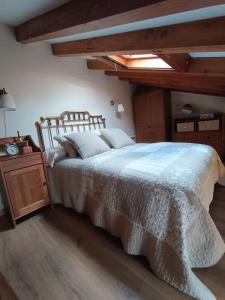 a bedroom with a large bed and a wooden table at Casa Coba 