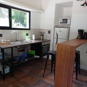 a small kitchen with a sink and a counter at Ruca Reuemn in Mar del Plata