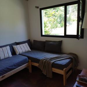 a couch in a room with a window at Ruca Reuemn in Mar del Plata
