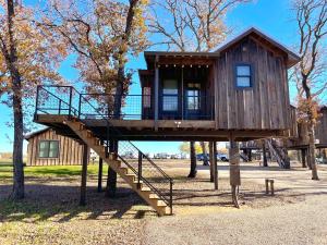 a tree house on a playground with a staircase at The Wren Treehouse 15 MIN to Magnolia Baylor 