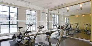 a gym with exercise bikes in a room with windows at Luxury 2 Bedroom Downtown in Toronto