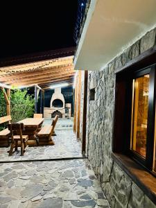 een patio met een tafel en een stenen muur bij Iepurasul Sinaia in Sinaia
