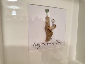 a display case with a tree branch and birds on it at Life of Filey - Part of the The Bay Filey Holiday Village with pool, gym and direct beach access, pub, restaurant, tennis and meadows walks in Reighton +41 photos