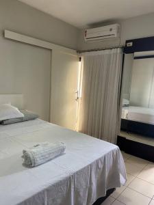 a bedroom with a bed with a towel on it at Flat completo no centro. in Palmas