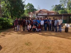 a group of people posing for a picture in front of a house at Vacanza Estate House in Kakkabe