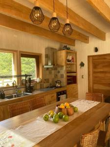 a kitchen with a table with a bowl of fruit on it at Preciosa casa V. Cerro Castillo cercana Parque in Villa Cerro Castillo +19 photos