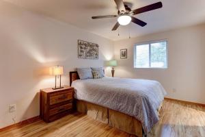 a bedroom with a bed and a ceiling fan at Western Skyline in Redmond