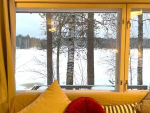 a window with a view of a snow covered field at Houses by The Sea in Salpar