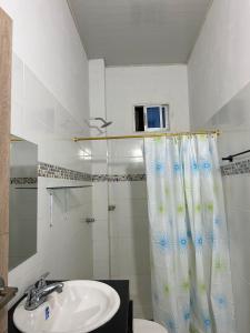 a bathroom with a sink and a shower curtain at ALTAVITA in Puerto Colombia