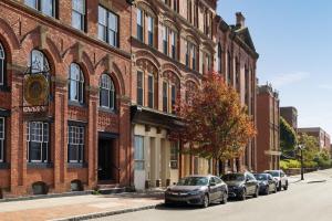 a row of cars parked in front of a brick building at Crowne Plaza Saint John Harbour View, an IHG Hotel in Saint John