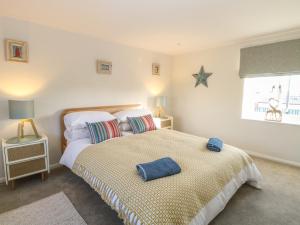 a bedroom with two beds and a starfish on the wall at Spring Cottage in Norwich