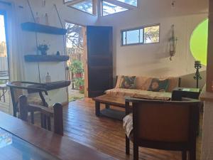 a living room with a couch and a table at Ruca lemu lodge in San Antonio