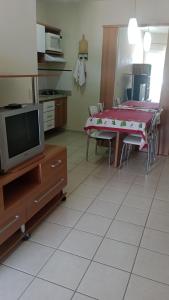 een woonkamer met een tafel en een televisie bij Ap Serra Park in Rio Quente