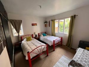 a bedroom with two beds and a window at Espacio Mycelium in Coihaique