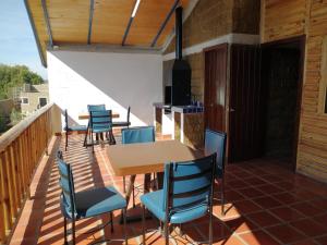 a patio with a table and chairs on a deck at LONGO VI in San Antonio de las Alzanas