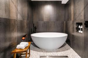 a bathroom with a large white bath tub on a marble floor at Payday by All Seasons Resort Lodging in Park City +26 photos