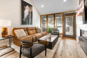 a living room with a couch and a fireplace at Payday by All Seasons Resort Lodging in Park City