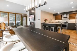 a kitchen with a large black table in a room at Payday by All Seasons Resort Lodging in Park City