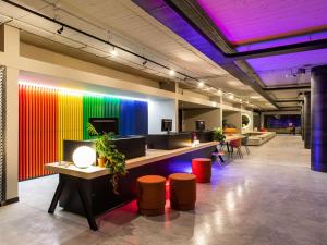a brightly lit office with a colorful wall at Ibis Styles Roma Aurelia in Rome