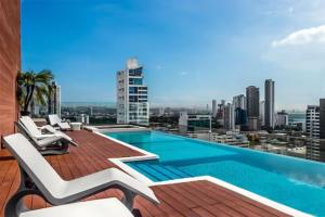 a swimming pool on the roof of a building at Fascinating Apartment City Center - PH Quartier Atlapa in Panama City