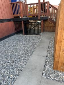 a patio with a walkway and a deck at Beautiful Suite In Cranbrook! in Cranbrook