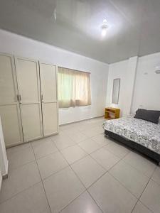 a white bedroom with a bed and a window at ARMANI in Puerto Colombia +17 photos