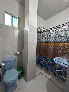 a bathroom with a blue toilet and a sink at ARMANI in Puerto Colombia