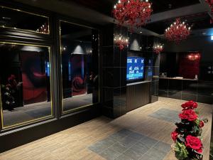un vestíbulo de un restaurante con flores rojas en primer plano en M'SCLUB OsakaHirano AdultOnly en Osaka