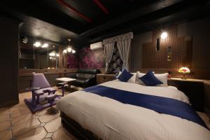 a bedroom with a large bed and a living room at M'SCLUB OsakaHirano AdultOnly in Osaka